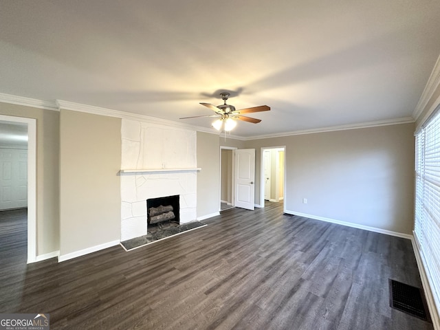 unfurnished living room featuring dark wood-type flooring, ornamental molding, and ceiling fan