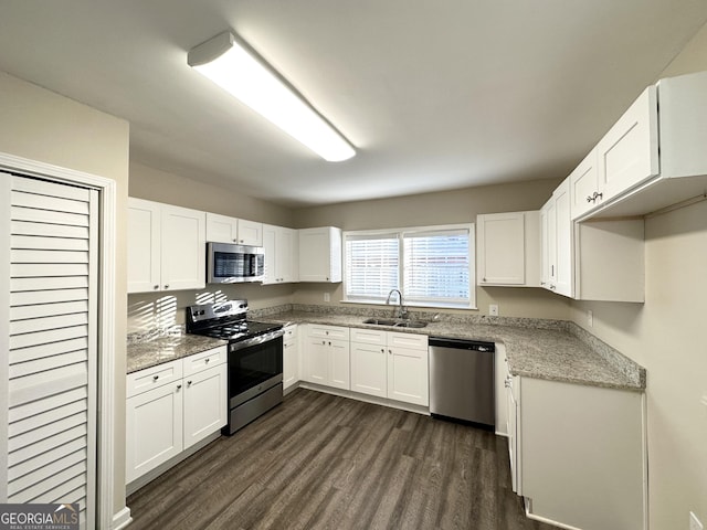 kitchen with white cabinetry, appliances with stainless steel finishes, dark wood-type flooring, and sink