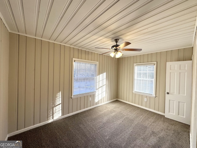 carpeted empty room featuring wooden ceiling and ceiling fan