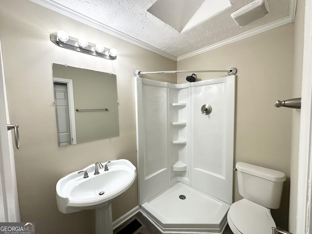 bathroom with crown molding, toilet, walk in shower, and a textured ceiling