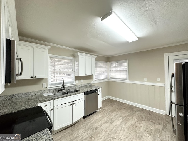 kitchen featuring white cabinetry, ornamental molding, appliances with stainless steel finishes, and sink