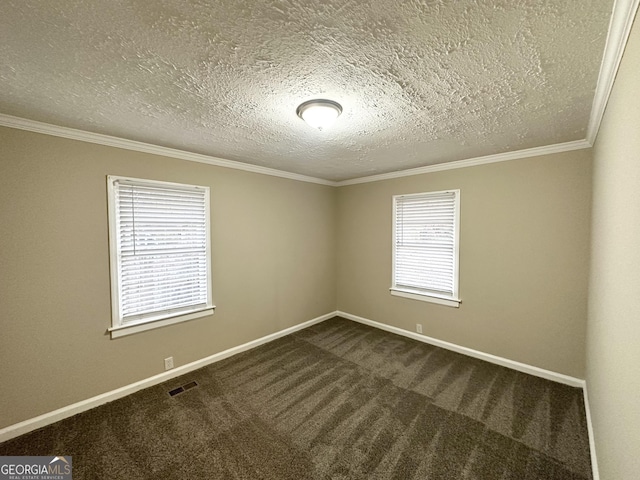 carpeted empty room with ornamental molding and a textured ceiling