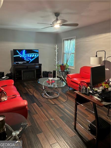 living room featuring ceiling fan and hardwood / wood-style floors