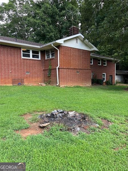 view of side of property with a lawn