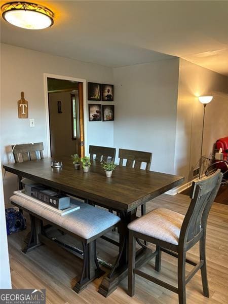 dining area with light hardwood / wood-style floors