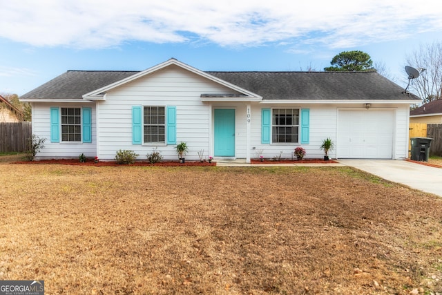 ranch-style house featuring a garage and a front lawn