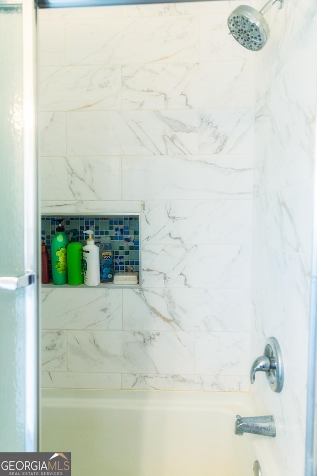 interior details with tiled shower / bath combo