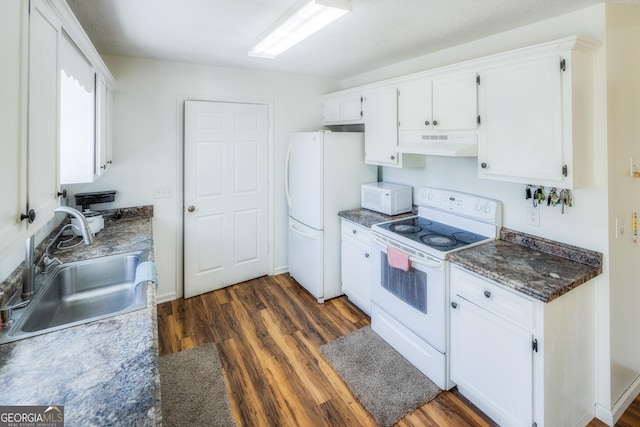 kitchen featuring sink, white appliances, a textured ceiling, white cabinets, and dark hardwood / wood-style flooring