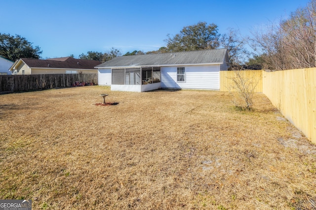 back of property with a lawn