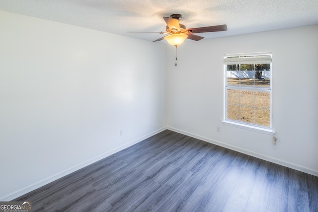 unfurnished room with ceiling fan, dark hardwood / wood-style flooring, and a textured ceiling