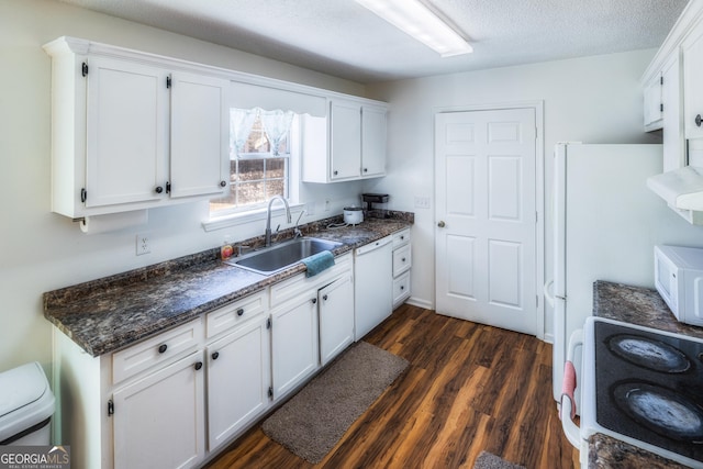 kitchen featuring sink, white cabinets, dark hardwood / wood-style flooring, white appliances, and a textured ceiling