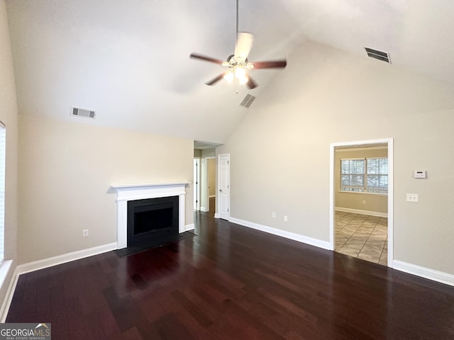 unfurnished living room featuring hardwood / wood-style flooring, ceiling fan, and high vaulted ceiling