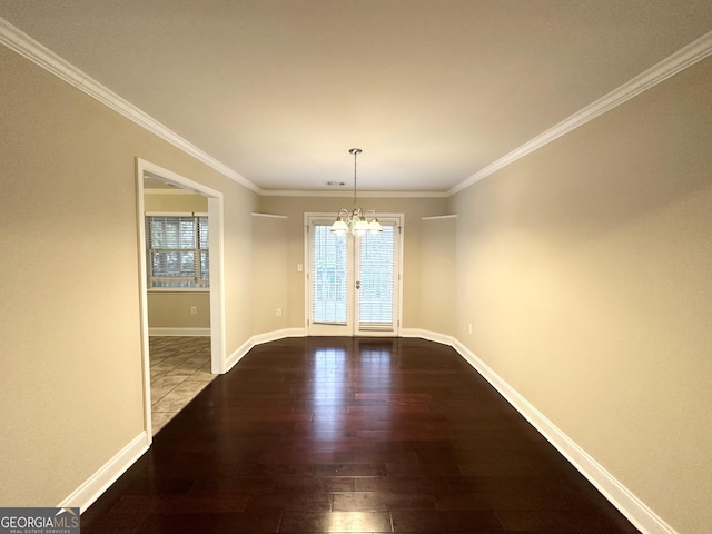 unfurnished dining area with ornamental molding, hardwood / wood-style floors, a notable chandelier, and french doors