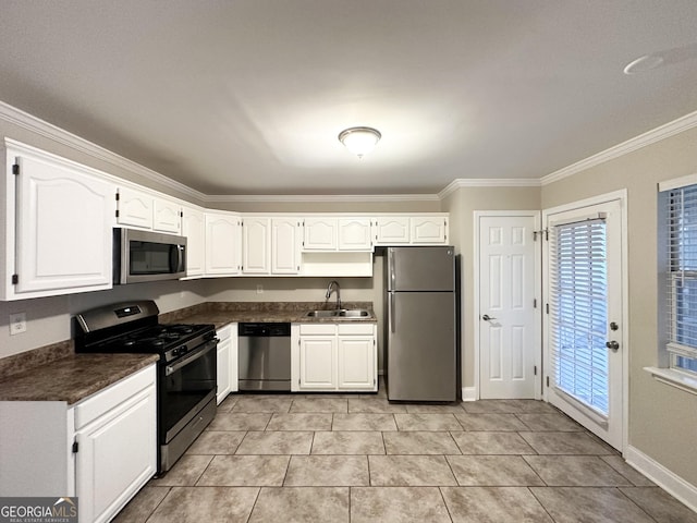 kitchen with sink, crown molding, light tile patterned floors, appliances with stainless steel finishes, and white cabinets