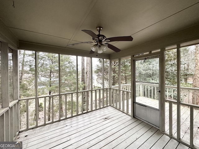 unfurnished sunroom with ceiling fan