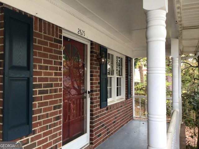 view of exterior entry with a porch