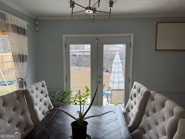 dining room with crown molding, french doors, and a textured ceiling