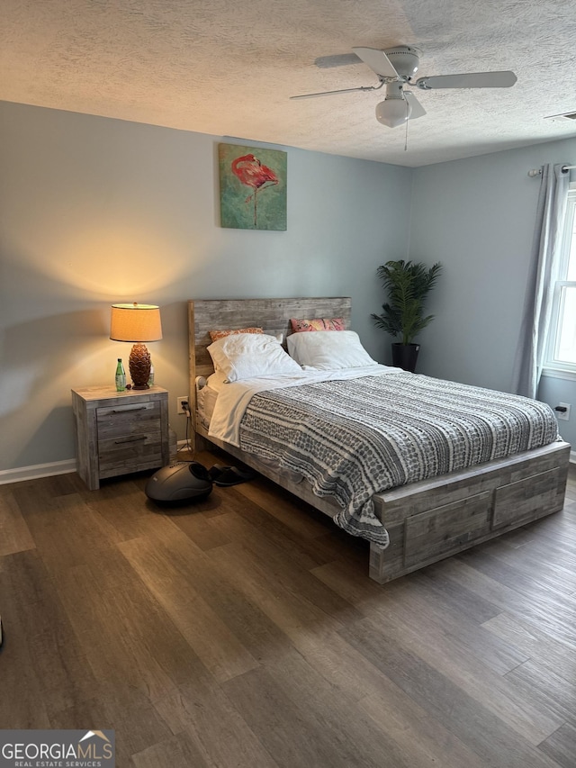 bedroom featuring hardwood / wood-style flooring, a textured ceiling, and ceiling fan