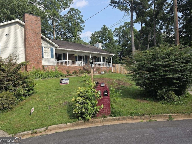 2615 Leeshire Ct, Tucker, GA 30084 - view of front of home with a chimney, a front yard, and covered porch