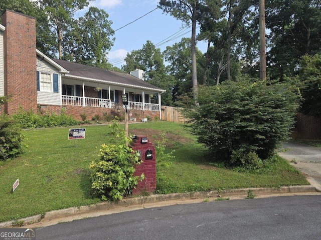 2615 Leeshire Ct, Tucker, GA 30084 - view of front of home with a chimney, a front lawn, brick siding, and a porch