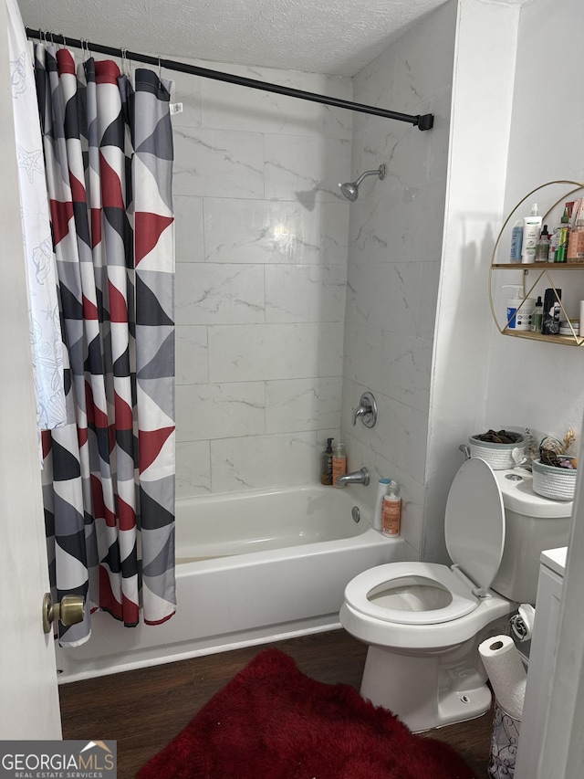 bathroom with shower / tub combo with curtain, toilet, hardwood / wood-style floors, and a textured ceiling