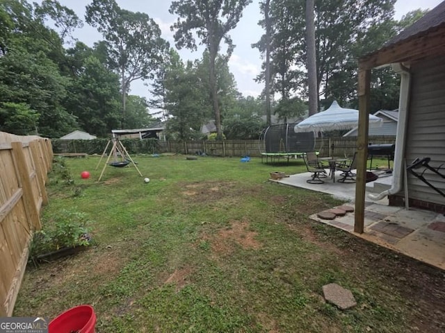 2615 Leeshire Ct, Tucker, GA 30084 - view of yard featuring a trampoline, a patio, and a playground