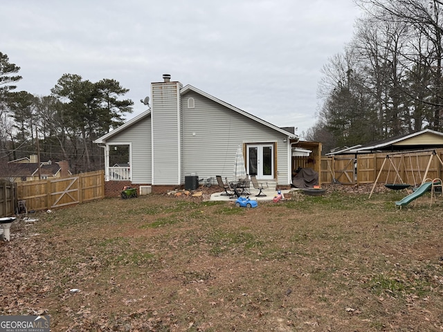 rear view of house featuring a patio area, central air condition unit, and a lawn