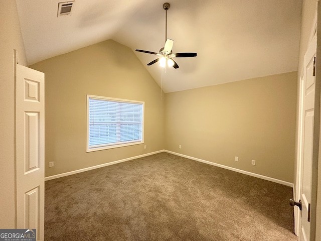 unfurnished bedroom featuring dark colored carpet, vaulted ceiling, and ceiling fan