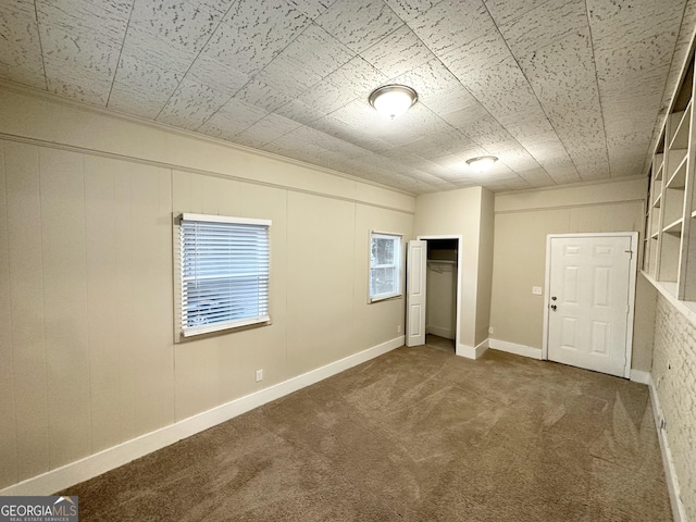 unfurnished bedroom featuring dark carpet