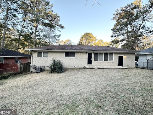 rear view of house with a lawn, central AC unit, and a patio area