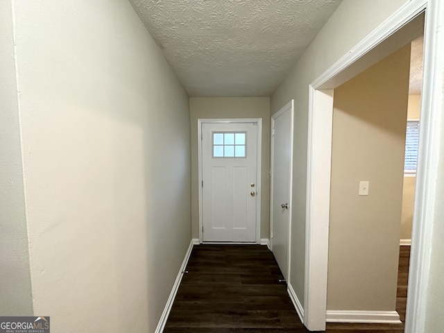 entryway featuring dark hardwood / wood-style floors and a textured ceiling