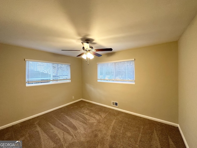 carpeted empty room featuring ceiling fan