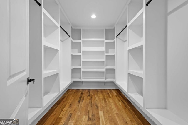 spacious closet featuring hardwood / wood-style flooring and a barn door