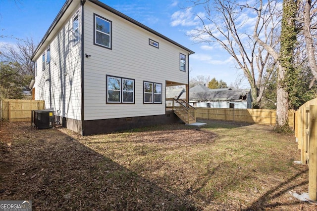 back of house with a yard and central AC unit