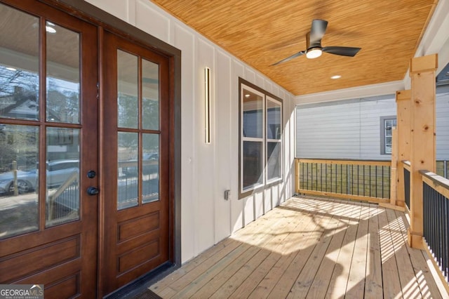 wooden deck featuring a porch and ceiling fan