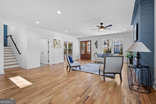 living room featuring ceiling fan and light hardwood / wood-style floors