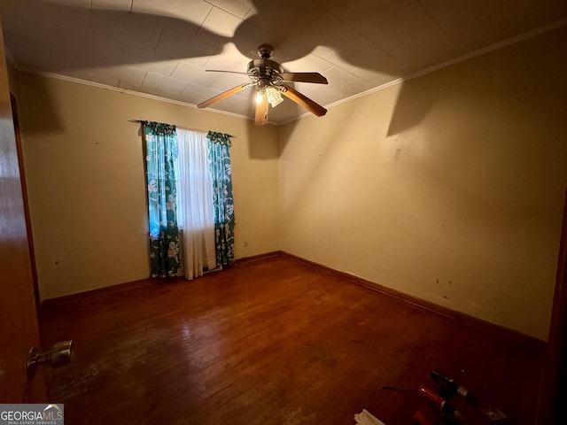 empty room with hardwood / wood-style flooring, ornamental molding, and ceiling fan