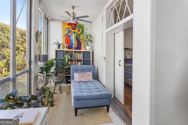 living area with ceiling fan and light tile patterned floors