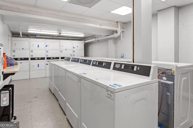 laundry area with stacked washer and dryer and washer and clothes dryer