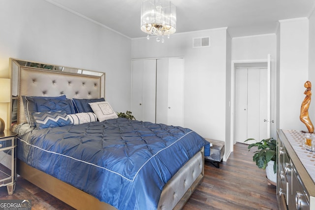 bedroom with dark hardwood / wood-style flooring, crown molding, and an inviting chandelier