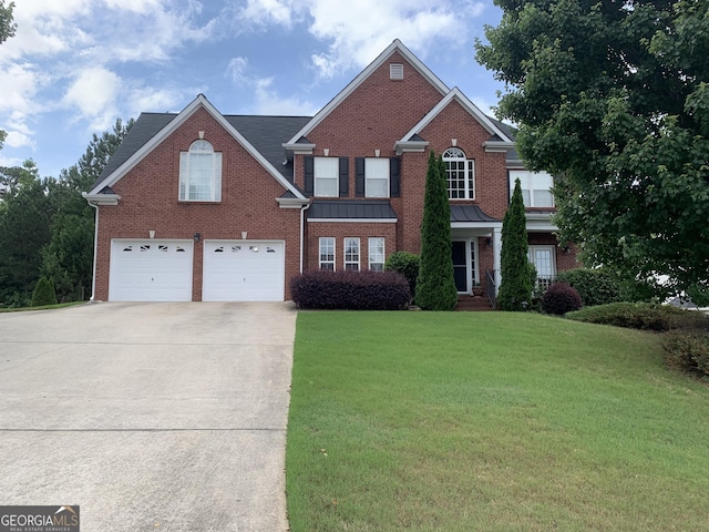 view of property with a garage and a front lawn