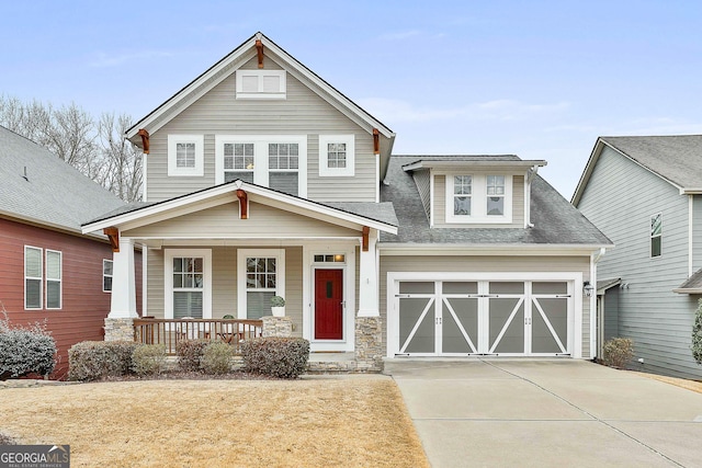 craftsman house with a porch and a garage