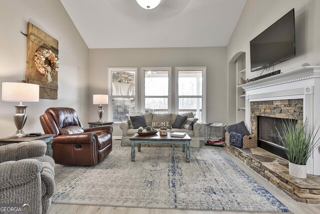 128 Greenview Dr, Newnan, GA 30265 - living area featuring vaulted ceiling, wood finished floors, a fireplace, and built in features