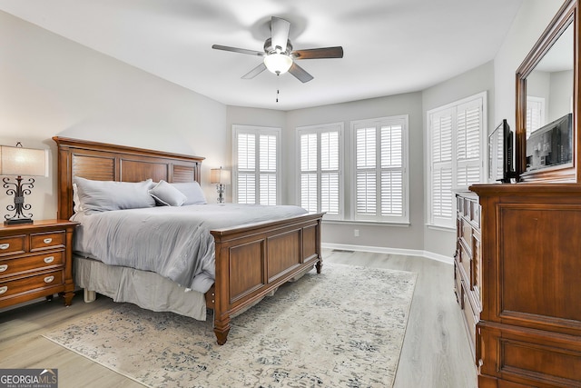 bedroom with light hardwood / wood-style flooring and ceiling fan