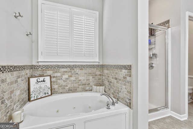 bathroom featuring tile patterned flooring, plus walk in shower, and toilet