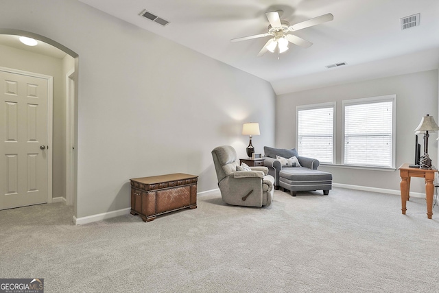 sitting room featuring lofted ceiling, light colored carpet, and ceiling fan