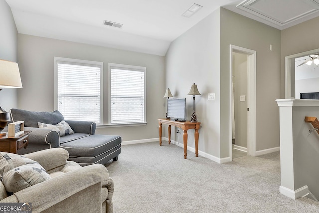 sitting room with lofted ceiling and light carpet