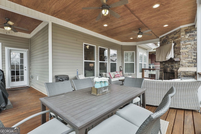 wooden terrace featuring an outdoor hangout area and ceiling fan