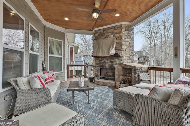 view of patio / terrace with an outdoor living space with a fireplace and ceiling fan