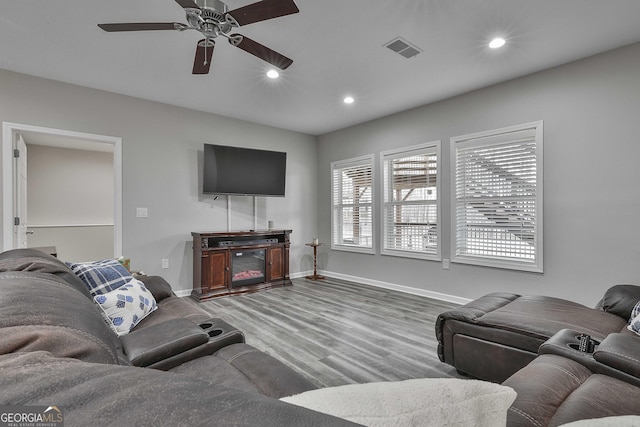 living room with hardwood / wood-style flooring and ceiling fan